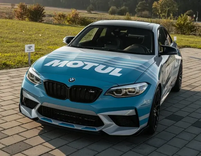 Phone photo of a blue sports car with racing livery